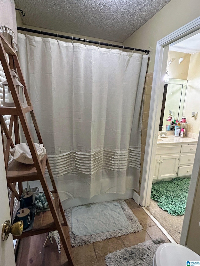 bathroom with vanity and a textured ceiling