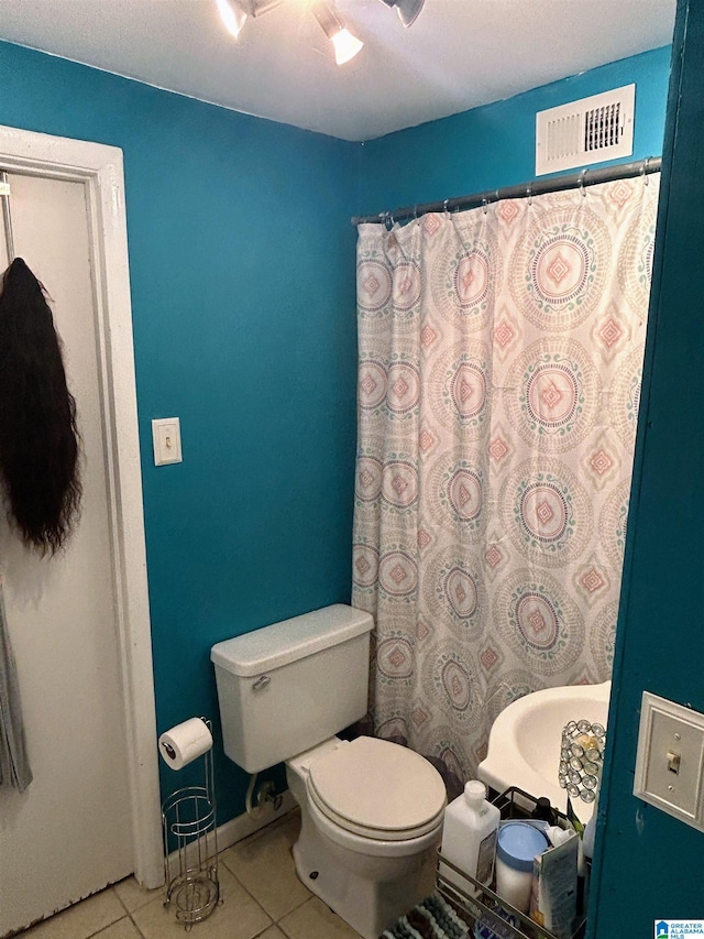 bathroom featuring tile patterned floors and toilet