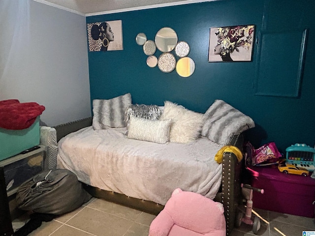 bedroom with tile patterned floors and crown molding