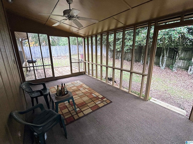 sunroom / solarium with ceiling fan and lofted ceiling