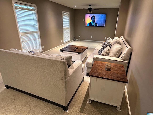 carpeted living room with ceiling fan