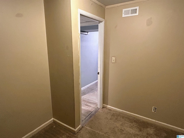 hall featuring dark colored carpet and ornamental molding