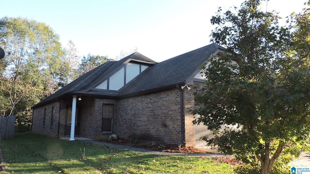 view of side of home featuring a yard