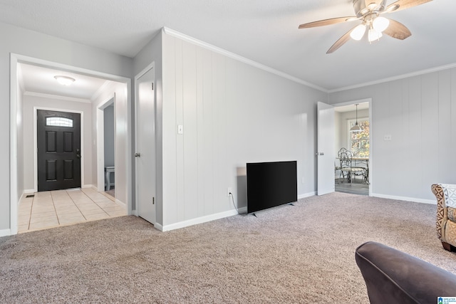 living room with ceiling fan, light colored carpet, crown molding, and wooden walls