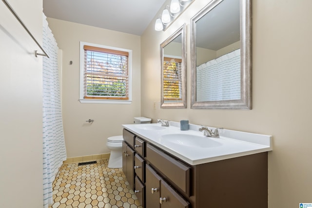 bathroom featuring tile patterned flooring, vanity, and toilet