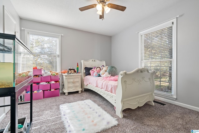 bedroom featuring a textured ceiling, carpet floors, and ceiling fan