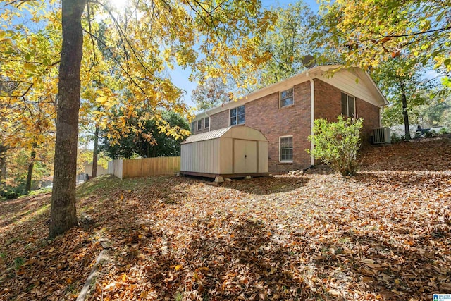 view of side of property with a storage shed