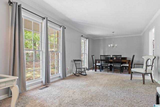 carpeted dining room featuring crown molding, plenty of natural light, and a chandelier