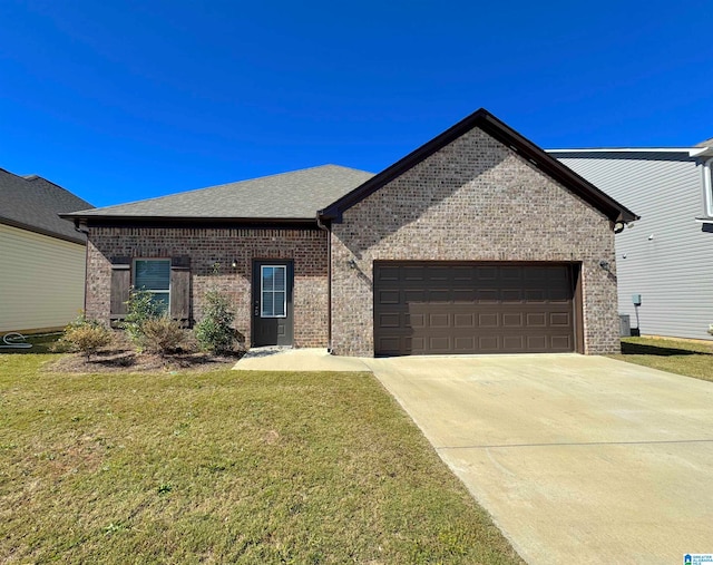 view of front of home with a garage and a front lawn