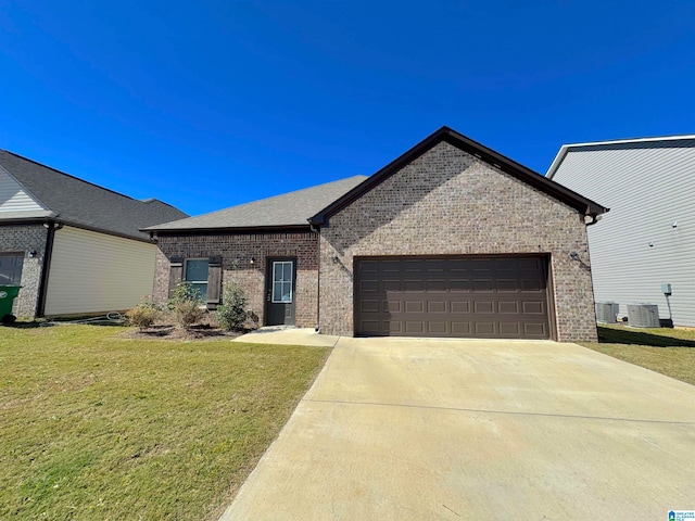 view of front of house with a front lawn, central air condition unit, and a garage