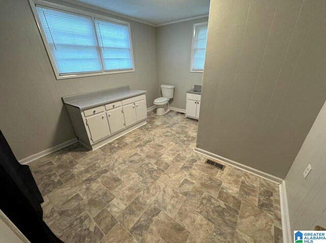 bathroom featuring vanity, toilet, and crown molding