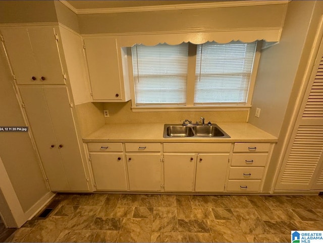 kitchen featuring sink and white cabinets