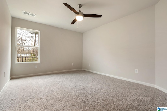 carpeted spare room with ceiling fan