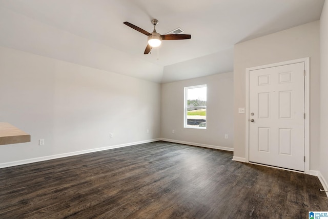 spare room featuring lofted ceiling, dark hardwood / wood-style floors, and ceiling fan