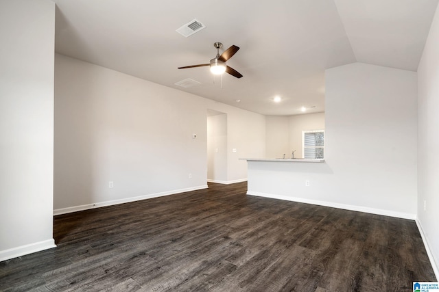 unfurnished living room with dark wood-type flooring, ceiling fan, and vaulted ceiling