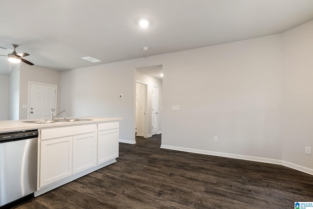 kitchen with stainless steel dishwasher, white cabinetry, sink, and dark wood-type flooring