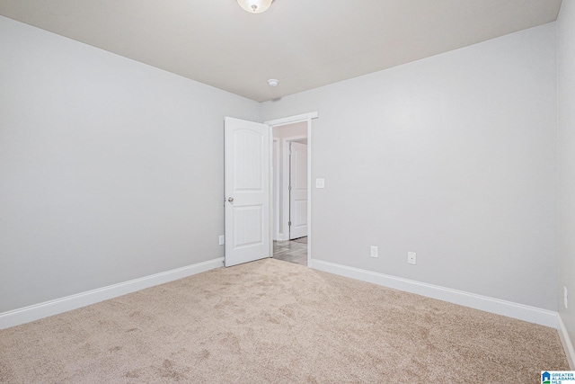 unfurnished room featuring light carpet