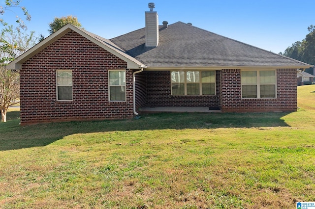 rear view of property with a yard