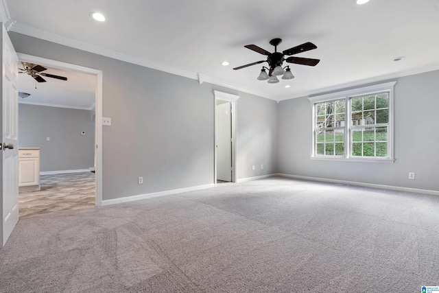 carpeted spare room with crown molding and ceiling fan