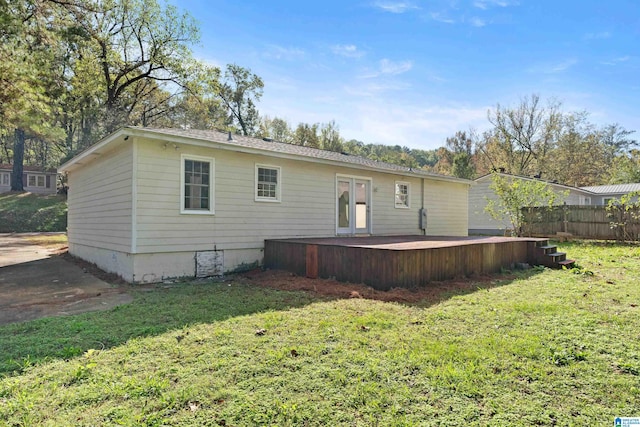 back of house with a lawn