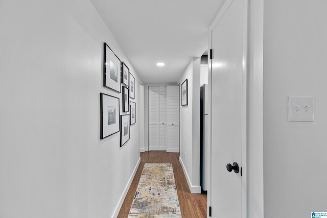 hallway with dark hardwood / wood-style floors