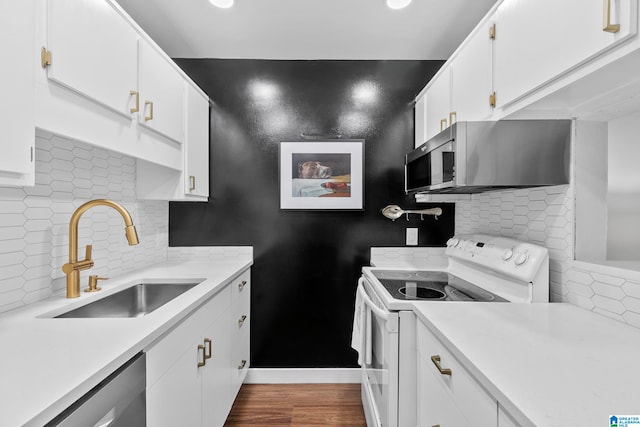 kitchen with white cabinetry, sink, appliances with stainless steel finishes, backsplash, and dark hardwood / wood-style flooring