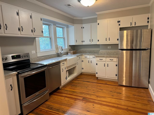 kitchen with white cabinetry, appliances with stainless steel finishes, and dark hardwood / wood-style floors