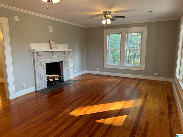 unfurnished living room with ornamental molding, hardwood / wood-style floors, ceiling fan, and a brick fireplace