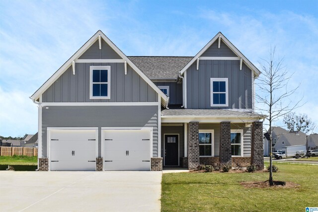 275 Avondale Ln, Pell City, AL 35128 - view of front facade with board and batten siding, concrete driveway, a garage, a shingled roof, and brick siding
