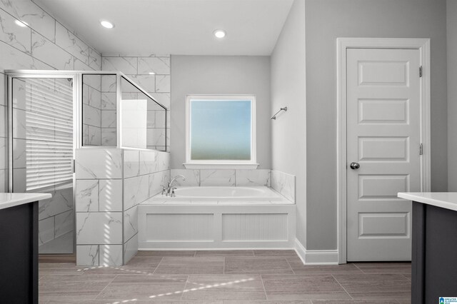 275 Avondale Ln, Pell City, AL 35128 - bathroom with a tile shower, a bath, recessed lighting, and baseboards
