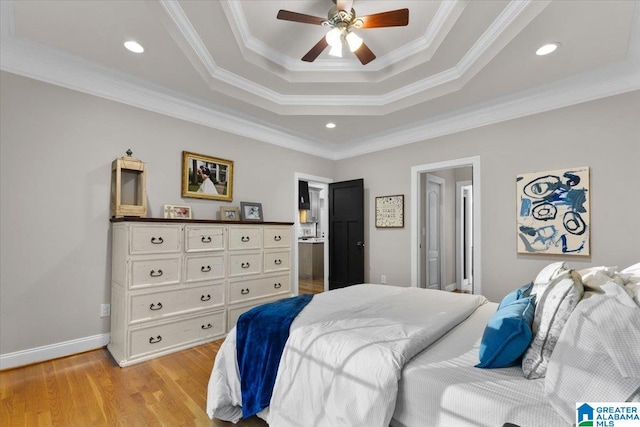 bedroom featuring ceiling fan, connected bathroom, light hardwood / wood-style flooring, and ornamental molding