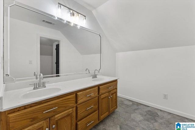 bathroom featuring vanity and lofted ceiling