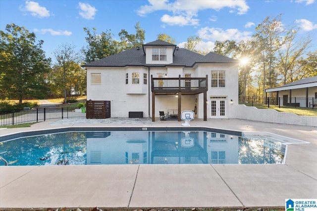 view of swimming pool featuring a patio and french doors