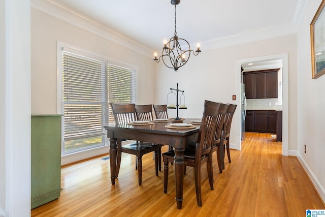 dining area with a chandelier, light hardwood / wood-style flooring, and ornamental molding