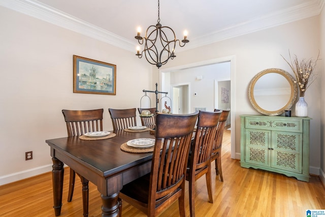 dining area featuring ornamental molding, light hardwood / wood-style flooring, and a notable chandelier