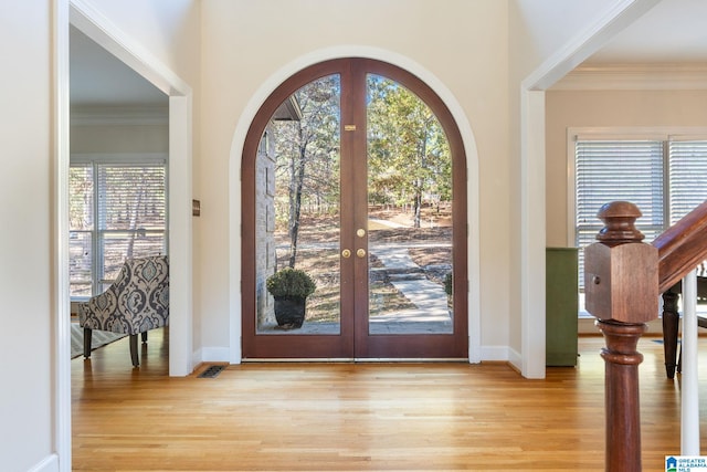 401 El Camino Real, Chelsea, AL 35043 - entryway featuring light wood-type flooring, french doors, crown molding, arched walkways, and baseboards