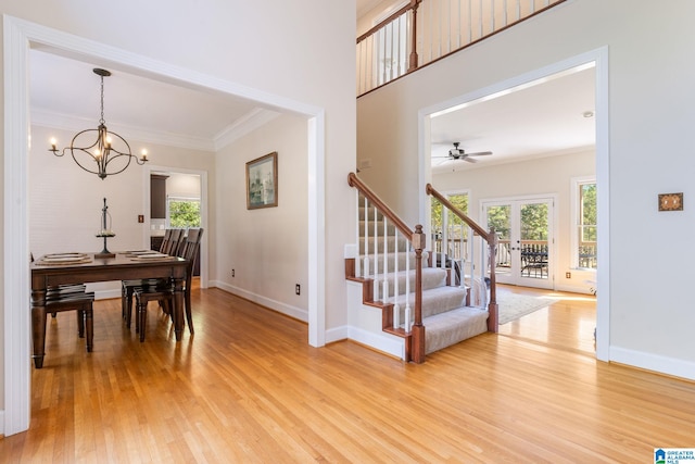 401 El Camino Real, Chelsea, AL 35043 - dining area featuring light wood-type flooring, a chandelier, stairway, baseboards, and crown molding
