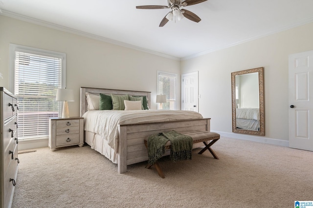 bedroom with light carpet, ceiling fan, and crown molding