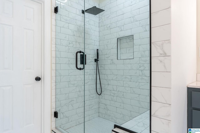 bathroom with vanity and a shower with shower door