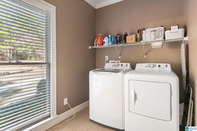 laundry room with washer and clothes dryer, crown molding, and light tile patterned flooring