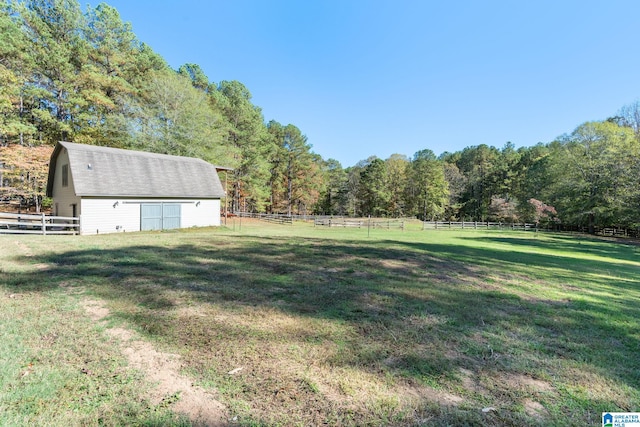 view of yard featuring a rural view and an outdoor structure