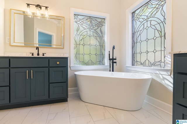 401 El Camino Real, Chelsea, AL 35043 - full bath with marble look tiles, baseboards, a freestanding tub, and plenty of natural light