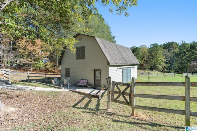 view of outbuilding with a yard and a rural view