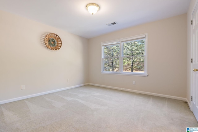 spare room featuring light colored carpet