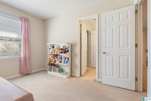 recreation room featuring light colored carpet