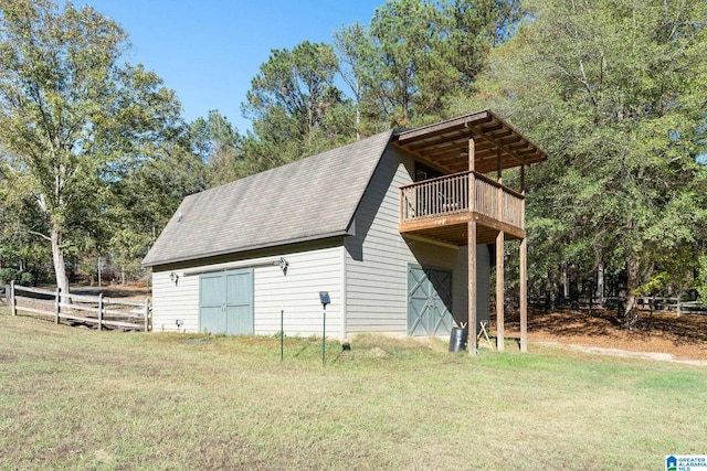 exterior space featuring a lawn and a balcony