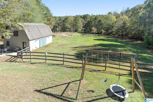 view of yard with a rural view and an outbuilding