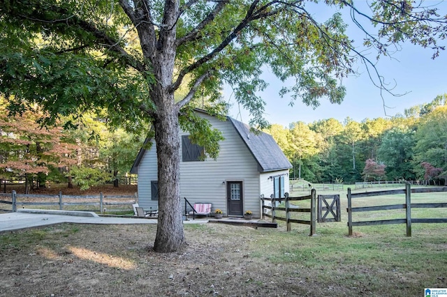 view of side of home featuring a lawn