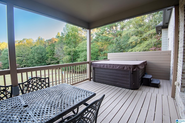 wooden deck with a hot tub