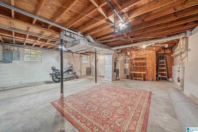 basement with electric panel, water heater, and heating unit